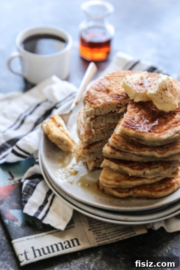 Fragrant Vietnamese Coffee Pancakes with Whipped Cinnamon Butter 5 A stack of golden brown Vietnamese Coffee Pancakes drizzled with maple syrup