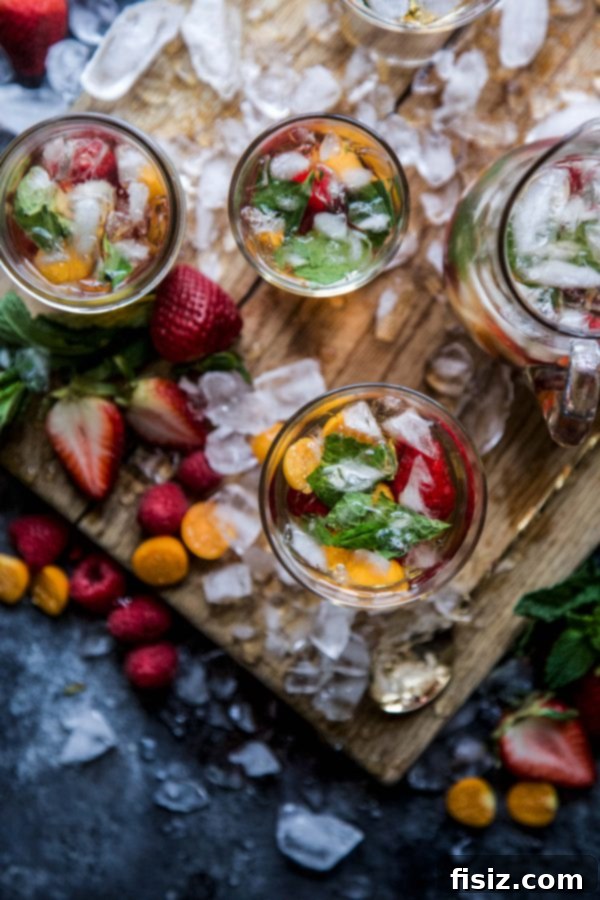 Minty Sweet Tea Sangria 3 Two glasses of Sweet Tea Sangria with Fresh Mint and a pitcher