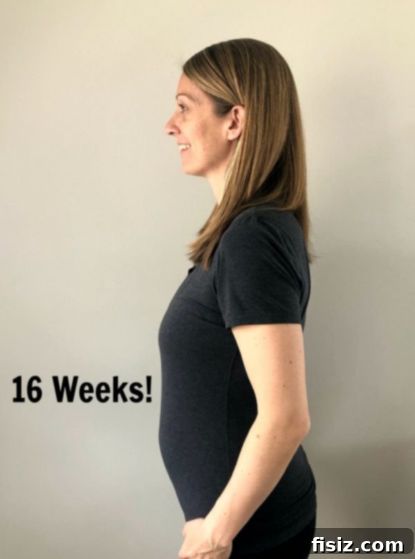 Second Trimester Milestones: My Weeks 14-18 Journey 7 Expecting mother holding her baby bump during a prenatal appointment