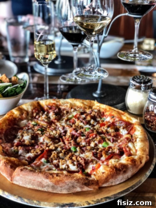 Fredericksburg Texas Explore Stay Dine 11 Wine bottle and glass with a scenic vineyard view at Stouts Trattoria