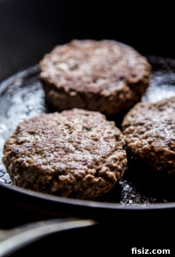 American Lamb Fry Burger 4 Assembling the American Lamb & Frites Burger with cheese and other fresh ingredients.