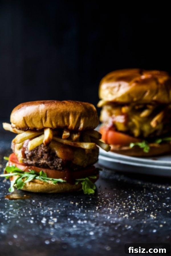 American Lamb Fry Burger 5 The fully assembled American Lamb & Frites Burger, topped with fries, ready to be served.