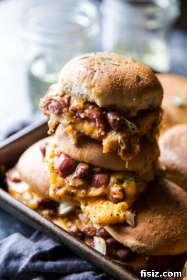 Baked Chili Cheese Dog Sliders 2 Close-up of freshly baked Chili Cheese Dog Sliders, golden brown and bubbling with cheese