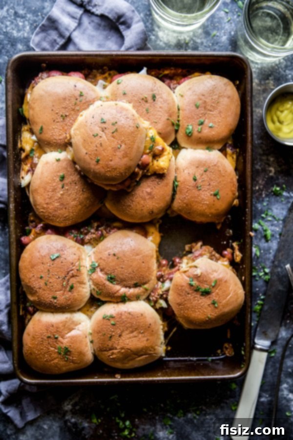 Baked Chili Cheese Dog Sliders 5 Chili Cheese Dog Baked Sliders, perfectly golden and garnished with fresh parsley