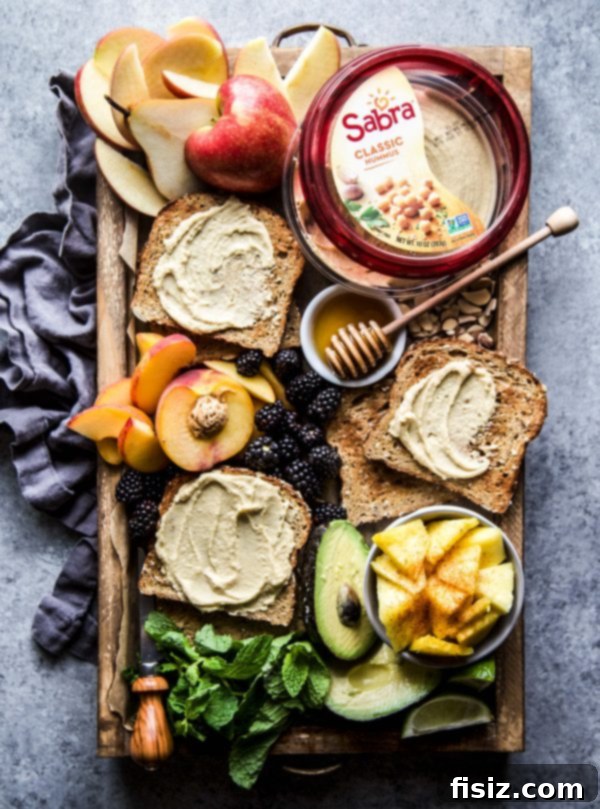 Three Delicious Hummus Toast Breakfasts 4 Overhead shot of two different Hummus Breakfast Toast variations on a rustic wooden board