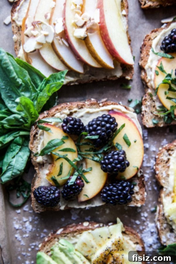 Three Delicious Hummus Toast Breakfasts 5 Hummus Breakfast Toast topped with fresh peach slices, blackberries, and basil leaves
