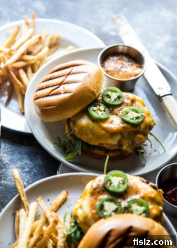 Signature Spiced Chicken Burgers 5 Close-up of a perfectly grilled Spiced Chicken Burger with melted cheddar.