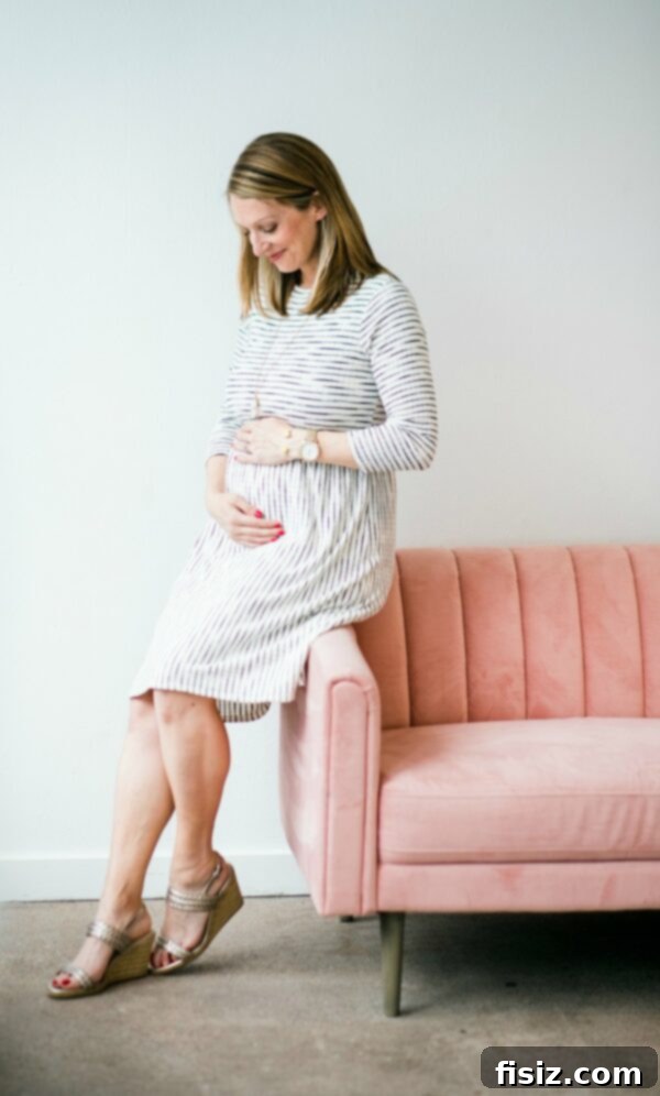 Mid-Pregnancy Check-in: Weeks 19-22 2 Pregnant belly progress in a patterned dress, showcasing the growing baby bump.