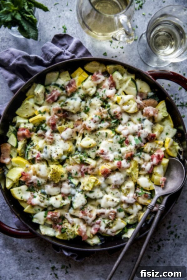 Smoky Cheesy Summer Squash Bake 2 Delicious Cheesy Bacon Summer Squash in a white baking dish, ready to be served
