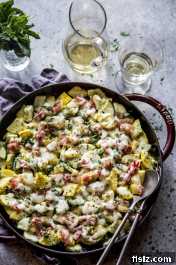 Smoky Cheesy Summer Squash Bake 5 Freshly baked Cheesy Bacon Summer Squash in a white dish, garnished with herbs