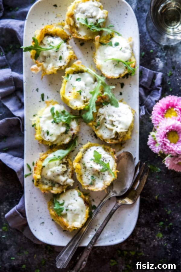 Close-up of baked Burrata and Pesto Spaghetti Squash Muffin Pizzas in a muffin tin