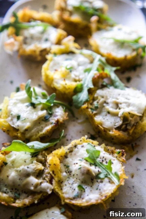 Close-up of a single Burrata and Pesto Spaghetti Squash Muffin Pizza garnished with fresh parsley