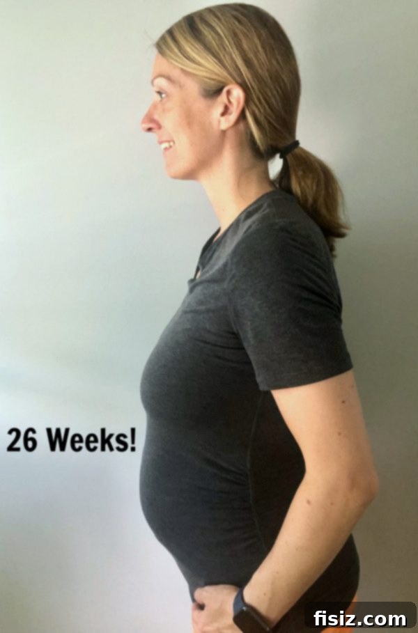 My Bump Update Weeks 23-27 8 Pregnant woman preparing food on a charcuterie board, focusing on healthy eating during pregnancy.