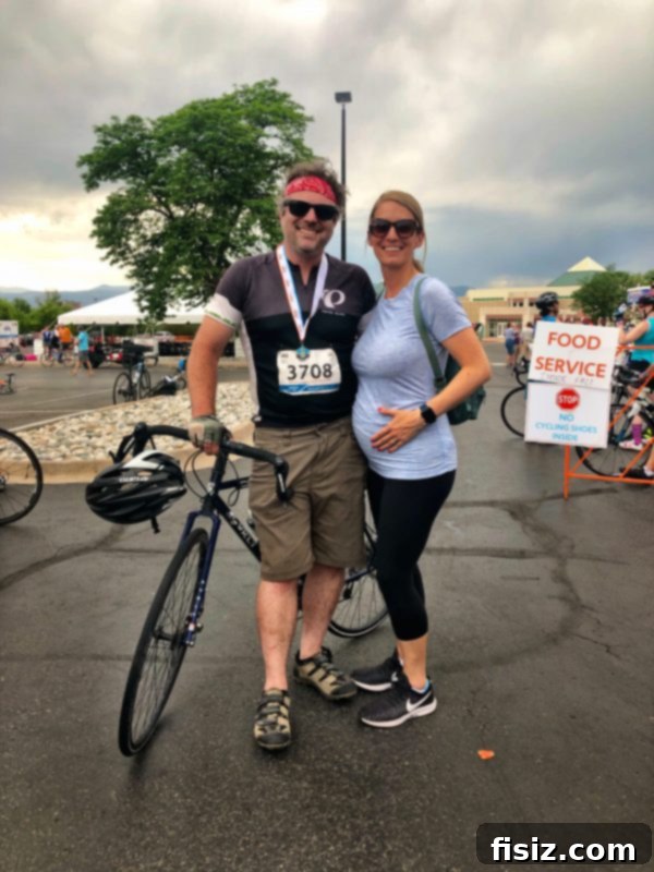 My Bump Update Weeks 23-27 10 Pregnant woman with her partner at a finish line, proudly displaying her baby bump, celebrating an achievement.
