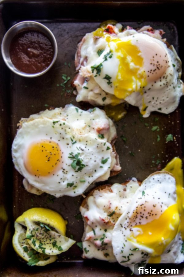 Serving a freshly prepared Lobster Croque Madame with a runny sunny-side up egg.