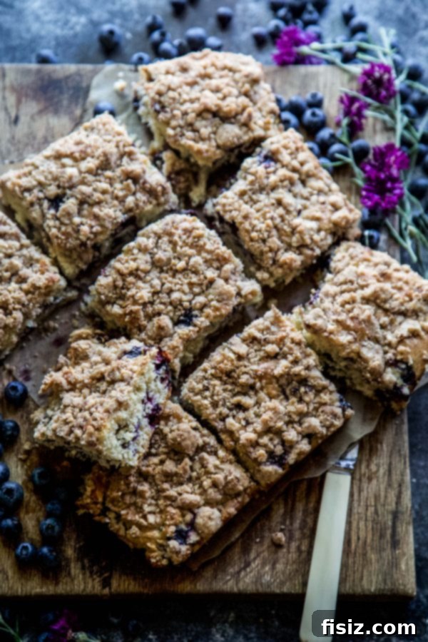 Cardamom-Kissed Blueberry Buckle Cake 3 Blueberry Cardamom Buckle Cake slice ready to be served
