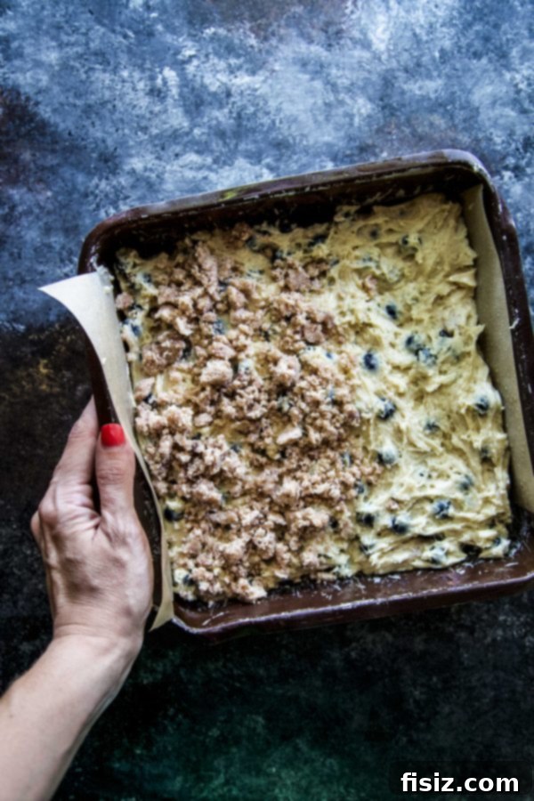 Cardamom-Kissed Blueberry Buckle Cake 5 A whole Blueberry Cardamom Buckle Cake on a cooling rack