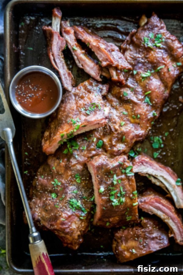 Apple Butter BBQ Ribs 3 Closeup of BBQ Apple Butter Baked Ribs on a platter, garnished