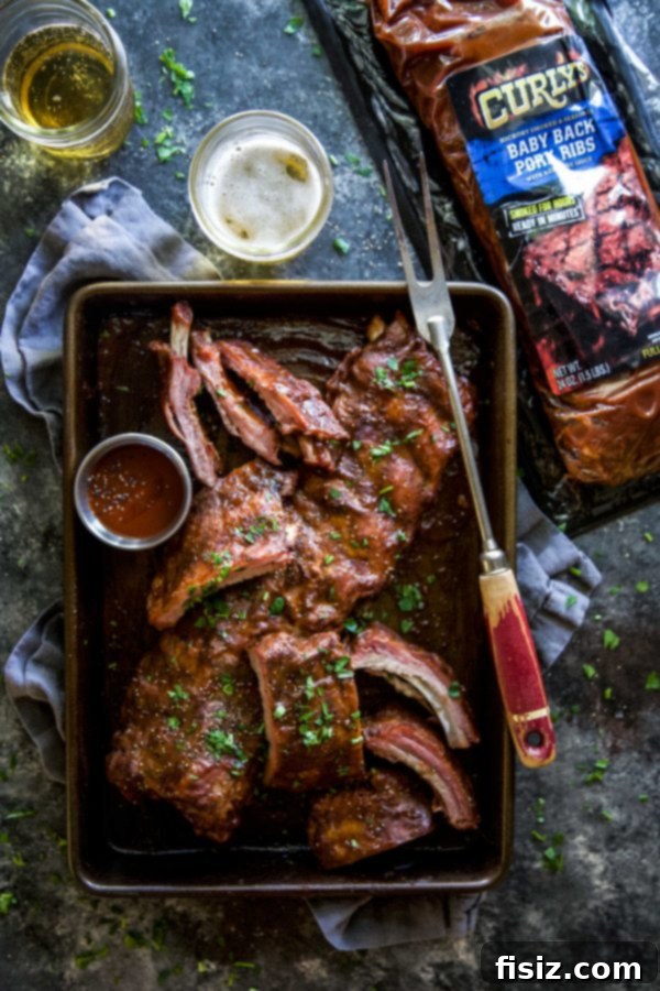 Apple Butter BBQ Ribs 5 Uncooked Curly's Ribs on a baking sheet, ready for the glaze