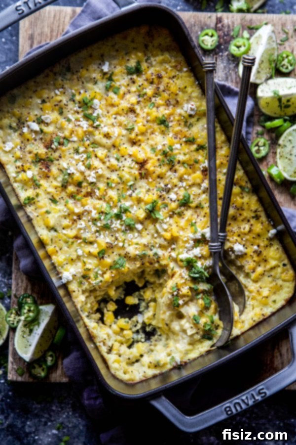 Mexican Street Corn Pudding 6 A bowl of Elote Corn Pudding, garnished with lime and cilantro, ready to eat