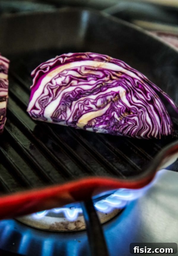 Vibrant Grilled Purple Wedge Salad 4 Beautifully plated Grilled Purple Cabbage Wedge Salad, garnished with fresh feta and parsley