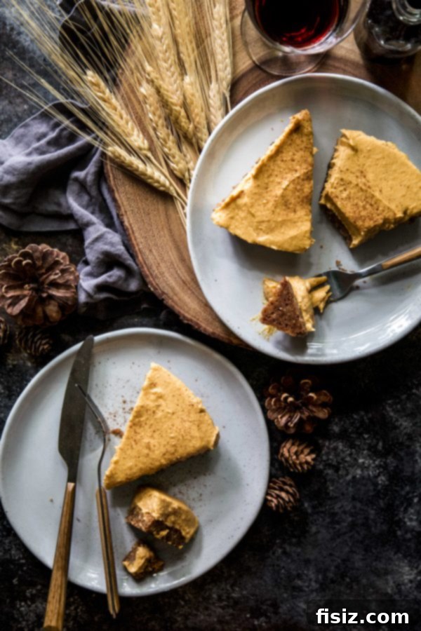 Velvet Pumpkin and White Chocolate Mousse Pie 5 A slice of Pumpkin and White Chocolate Mousse Pie with a fork, showing the distinct layers