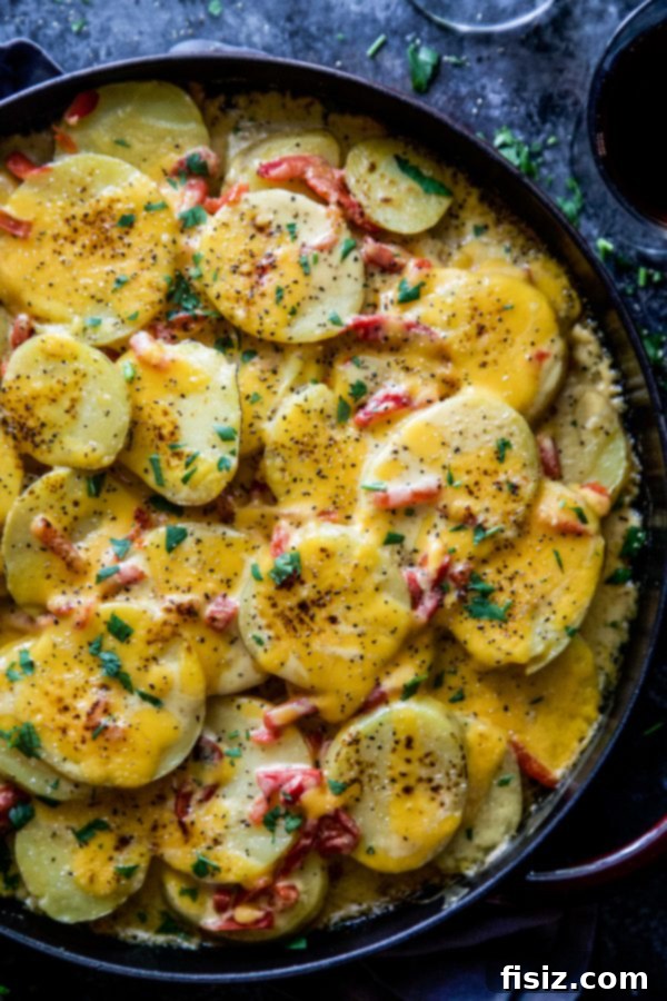 Freshly baked Chipotle Pimento Cheese Au Gratin Potatoes, garnished with parsley