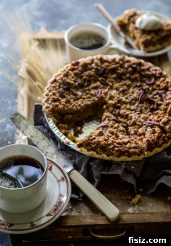Decadent Salted Bourbon Pumpkin Pie with Pecan Streusel 6 Full Salted Bourbon Pumpkin Pie with Pecan Streusel on a rustic table