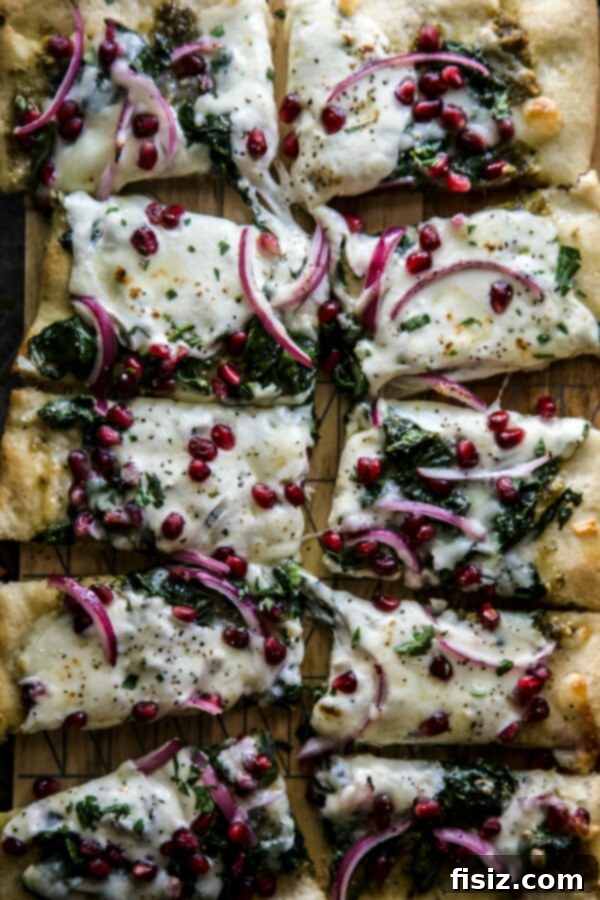 Vibrant Winter Greens and Pomegranate Pizza 2 Festive Winter Greens and Pomegranate Pizza on a wooden board, ready to serve