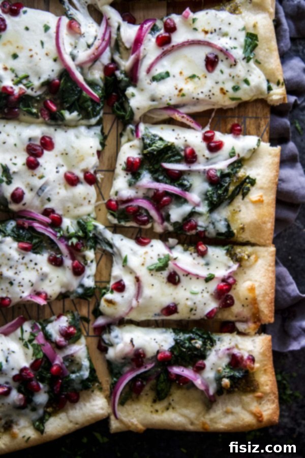 Vibrant Winter Greens and Pomegranate Pizza 5 Winter Greens and Pomegranate Pizza on a baking sheet, fresh from the oven