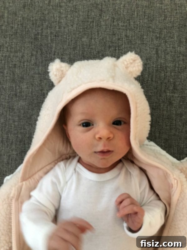 My Second Month With Charlie 9 Baby Charlie bundled up in a cozy outfit, looking at the camera with wide eyes.