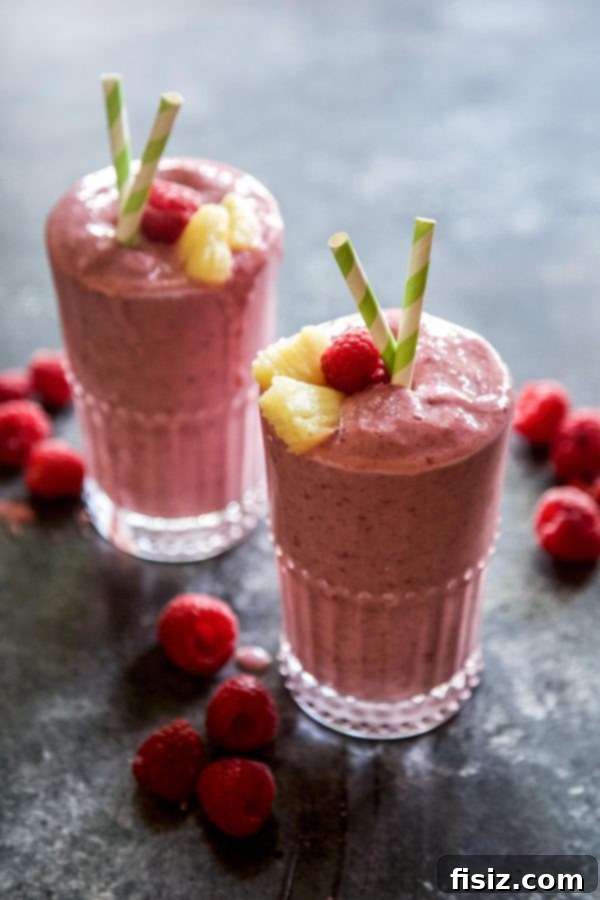 Tropical Raspberry Mango Protein Fuel 3 Delicious ingredients for a homemade Raspberry Mango Protein Smoothie are artfully arranged, ready for blending.