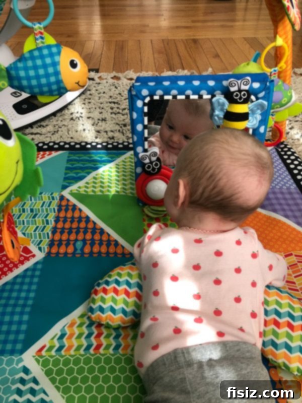 Three Months With Charlie 8 Baby Charlie happily playing on her colorful play mat, surrounded by stimulating toys