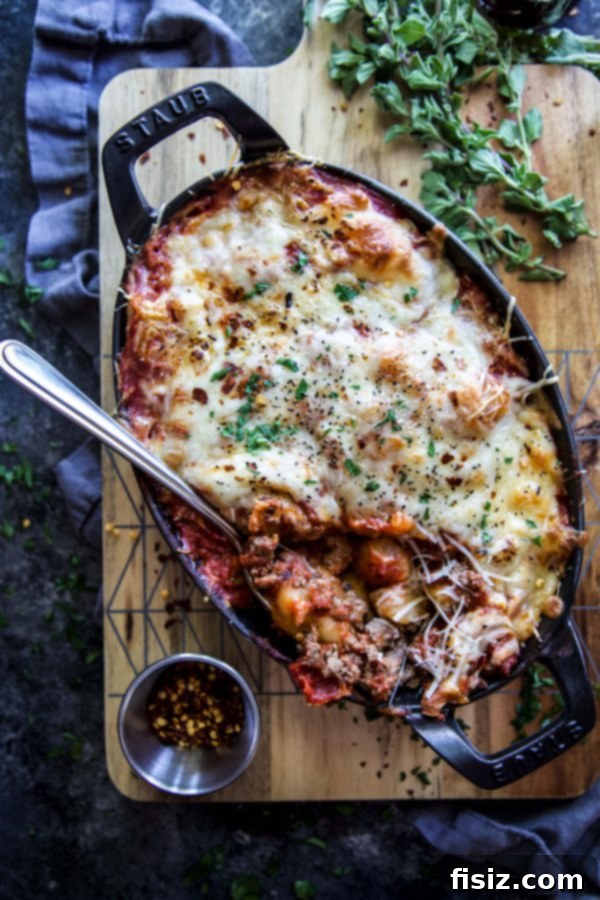 Golden Cheesy Turkey Cauliflower Gnocchi Bake 5 Overhead shot of Cheesy Turkey Cauliflower Gnocchi Bake in a cast iron skillet, beautifully golden and bubbly, ready to serve.