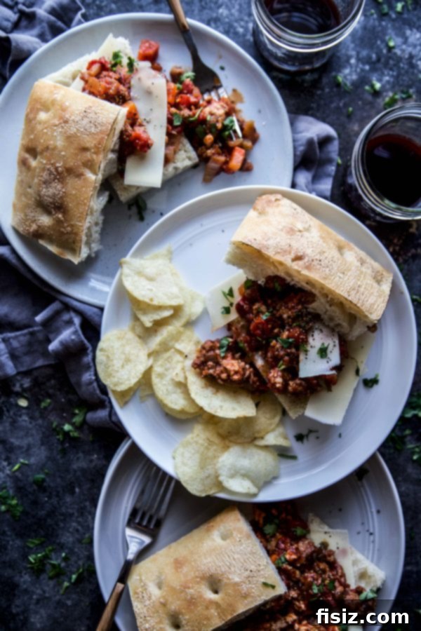Messy Bolognese Buns 5 Two Bolognese Sloppy Joes on focaccia slices, garnished with Parmesan