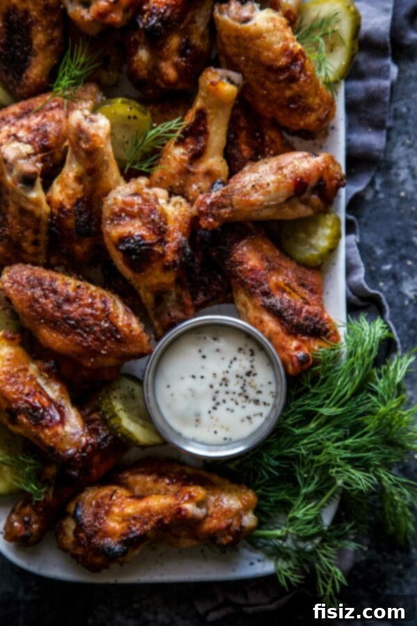 Pickleback Baked Chicken Wings arranged neatly on a serving platter with fresh dill and ranch dressing.