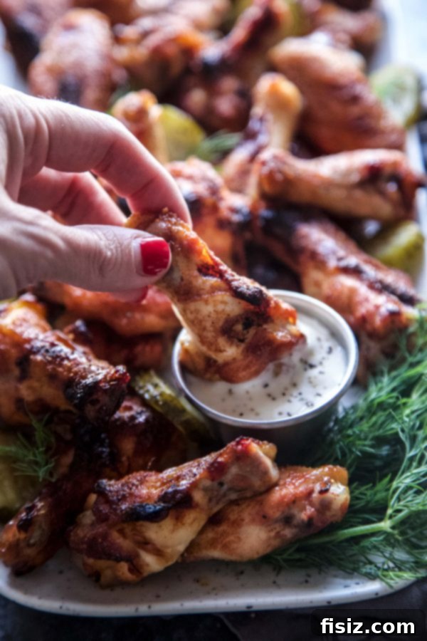 A close-up of a single Pickleback Baked Chicken Wing, showcasing its crispy skin and appealing glaze.