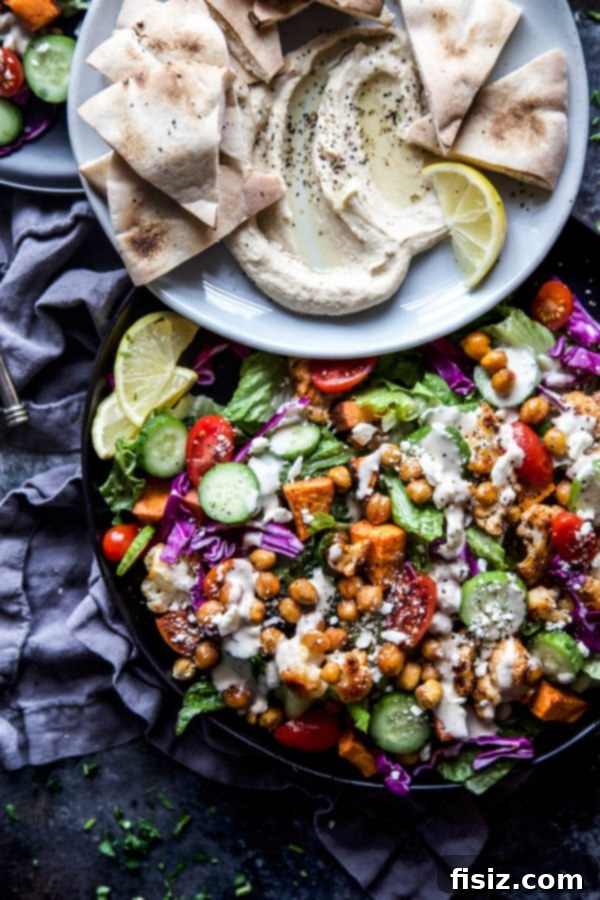 Vibrant Roasted Veggie Shawarma Bowls 6 A small bowl of creamy lemon tahini dressing with a spoon, ready to be drizzled over the shawarma bowls.