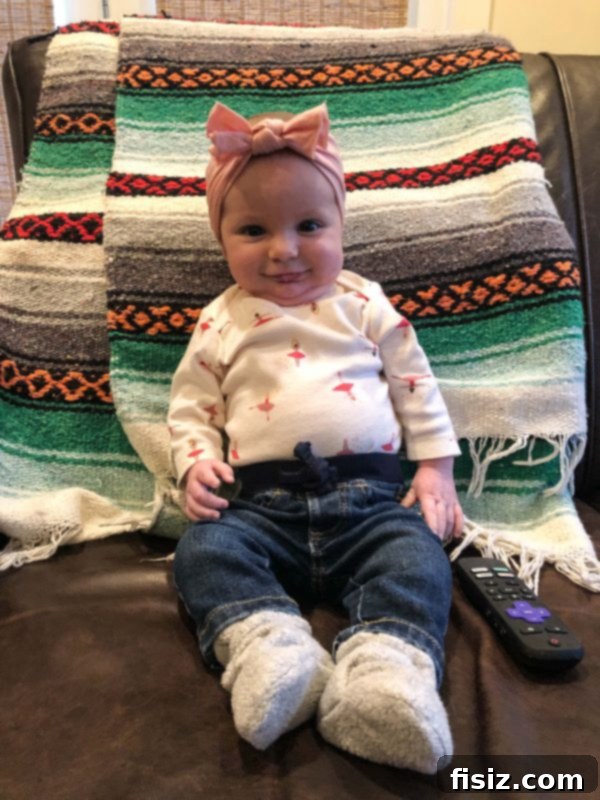 Four Months with Charlie 11 A curated flat lay of baby essentials: Doona car seat, Baby Bjorn Mini carrier, and Freshly Picked Diaper Backpack, perfect for active parents