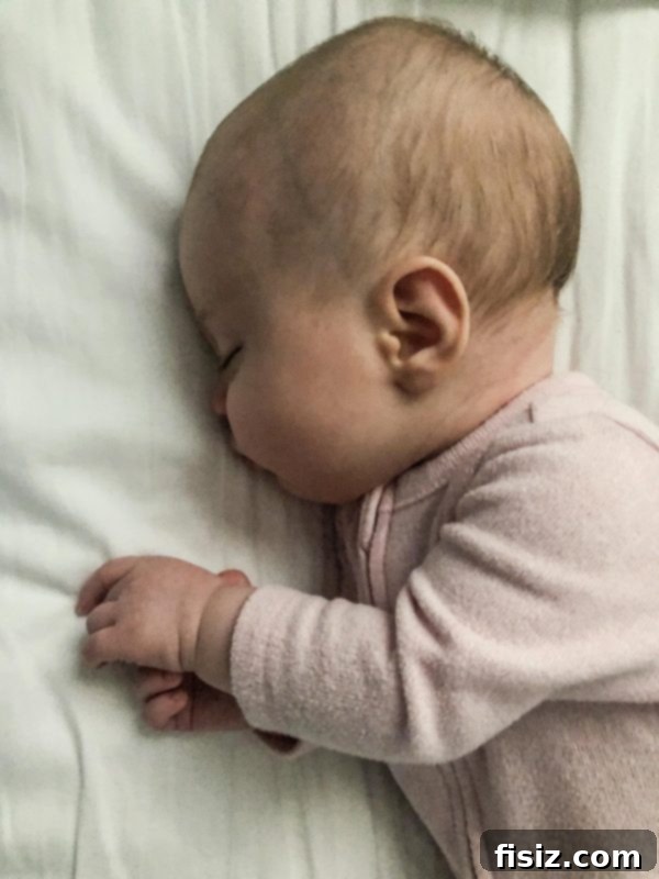 Four Months with Charlie 4 Baby Charlie lying on a patterned blanket, looking up with curiosity, dressed in a cute outfit