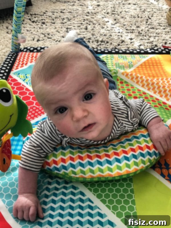 Four Months with Charlie 5 Charlie smiling brightly while sitting up with support, showcasing her growing personality