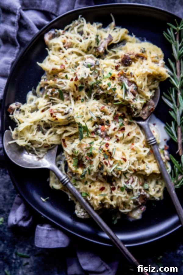 Herbed Creamy Spaghetti Squash 5 Creamy spaghetti squash being mixed with fresh herbs and mushrooms in a skillet.