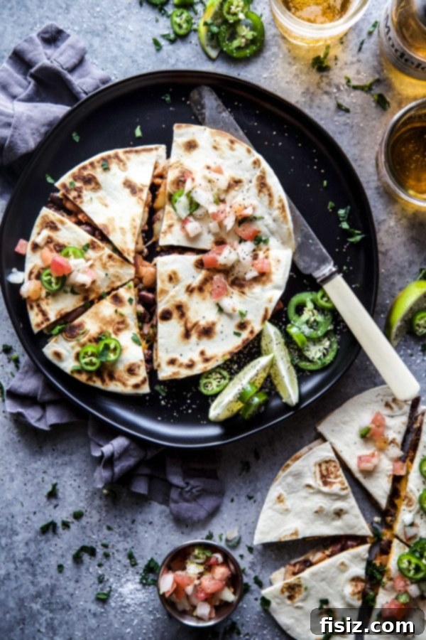 Irresistible Al Pastor Three Bean Quesadillas 2 Al Pastor Three Bean Quesadilla cooked to golden perfection on a plate