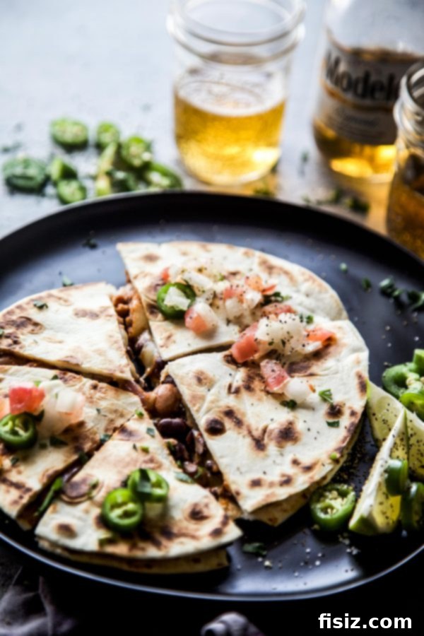 Irresistible Al Pastor Three Bean Quesadillas 3 Al Pastor Three Bean Quesadilla on a cutting board, ready to be served