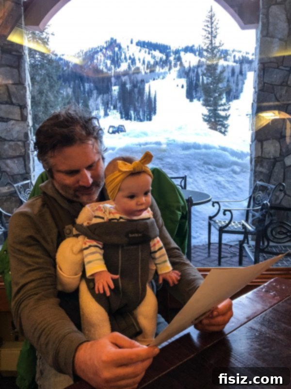Five Months with Charlie 11 Baby Charlie happily snuggled in a carrier during a family dinner on a ski trip