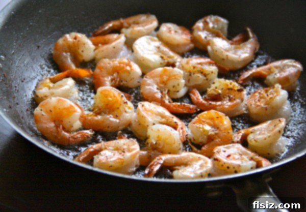 Close-up of golden brown shrimp and grit squares with bacon garnish