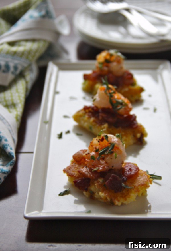 Platter of elegant shrimp and grit squares garnished with herbs