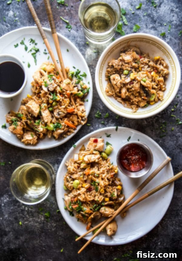 Effortless Homemade Chicken Fried Rice 6 Close-up of a large skillet brimming with freshly cooked chicken fried rice, ready to be served.