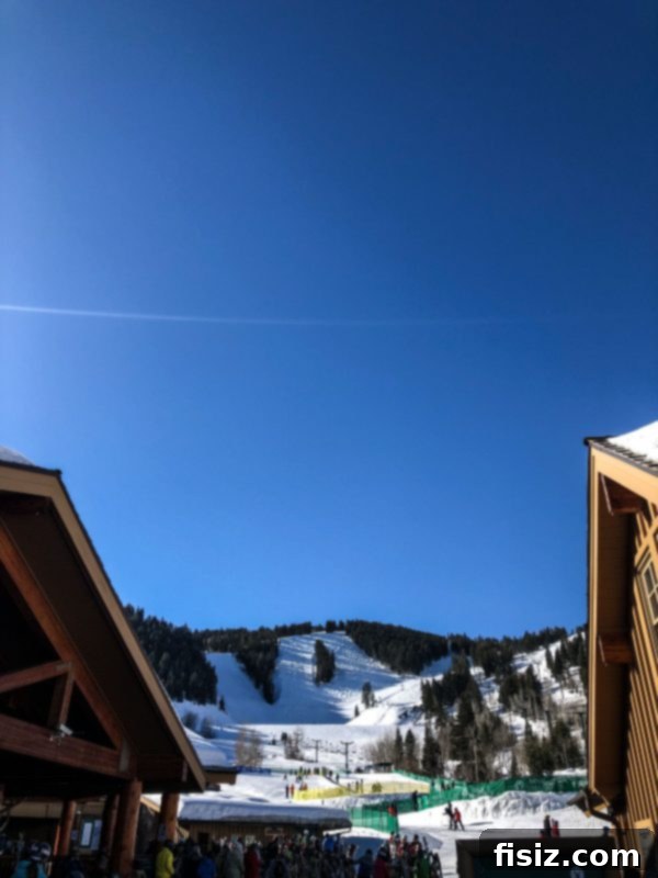 Deer Valley: The Ultimate Family Weekend 9 A lone skier gracefully glides down a perfectly groomed slope at Deer Valley