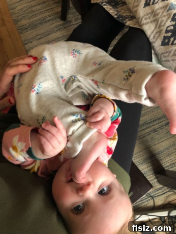 Half a Year with Charlie 6 Baby Charlie lying on her back, adorably holding her feet up and exploring her toes.